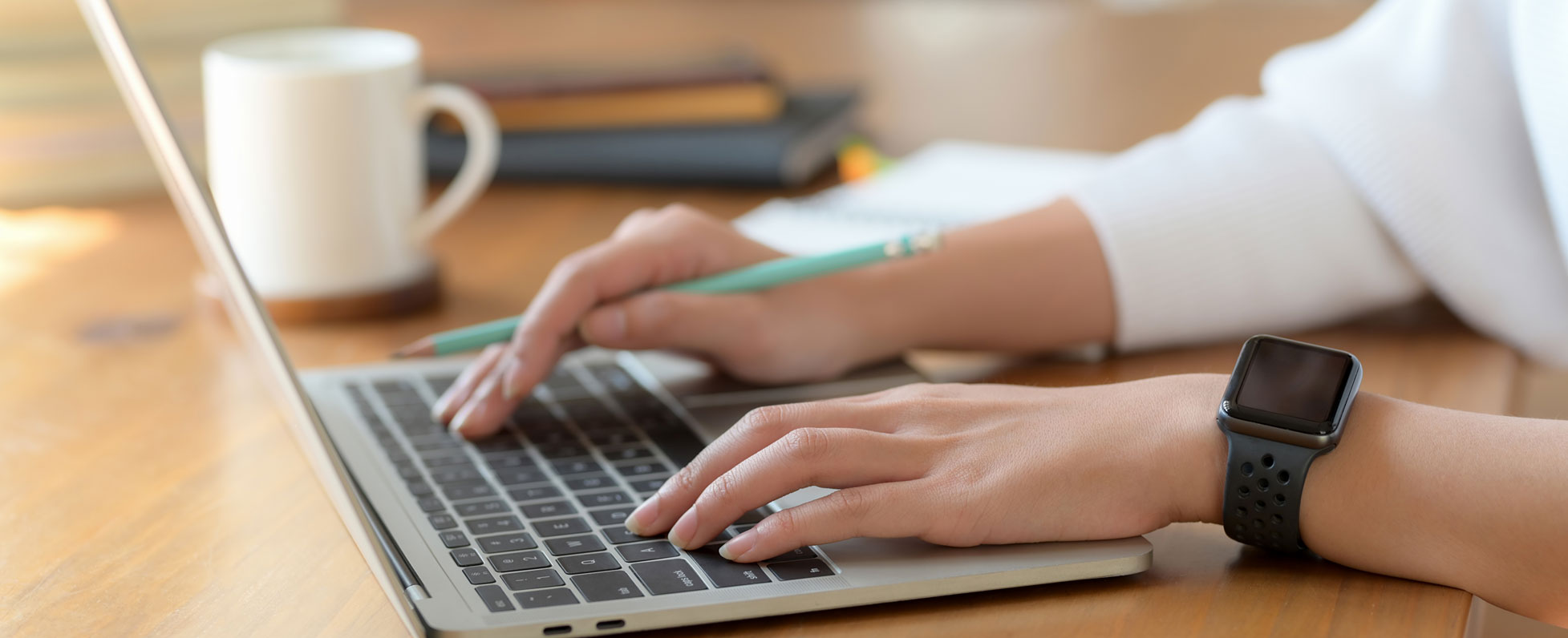 Hands on laptop keyboard